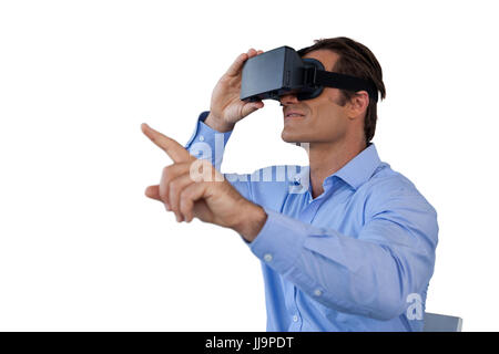 Businessman gesturing while using  virtual reality simulator against white background Stock Photo