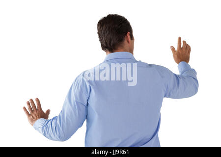 Businessman in blue shirt using interface against white background Stock Photo