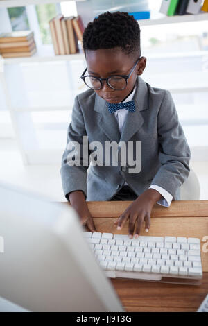 High angle view of businessman wearing eyeglasses using computer while working in office Stock Photo