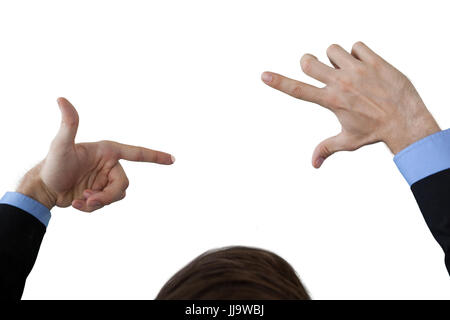 Cropped image of businessman doing finger frame gesture against white background Stock Photo