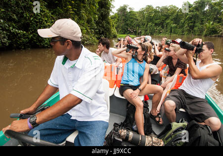 Tourists enjoying the canals looking for wildlife in Tortuguero National Park, Costa Rica. Stock Photo