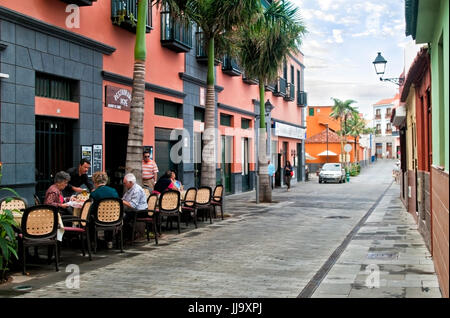 elderly spanish people sitting in a street restaurant in Puerto de la Cruz Stock Photo
