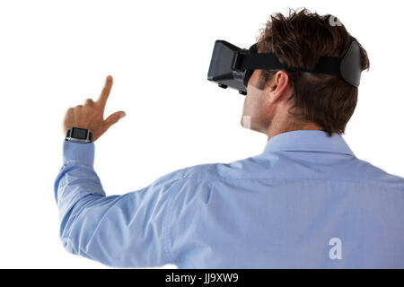 Rear view of businessman gesturing while using vr glasses against white backgrond Stock Photo