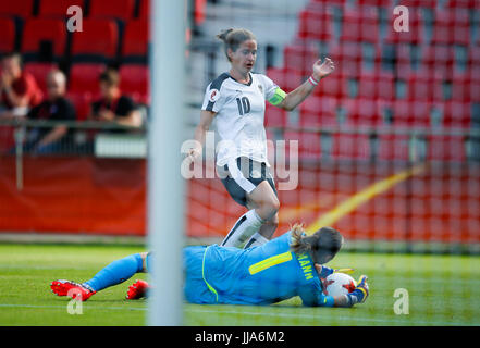 Deventer, Netherlands. 18th July, 2017. Goalkeeper Gaelle Thalmann of Switzerland blocks the shot by Nina Burger of Austria during a UEFA Women's EURO 2017 soccer tournament Group C match between Austria and Switzerland at the Adelaarshorst Stadium in Deventer, the Netherlands, July 18, 2017. The Austrians won the game 1-0. Credit: Ye Pingfan/Xinhua/Alamy Live News Stock Photo