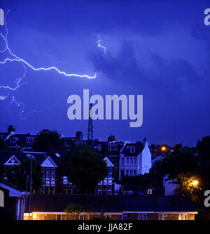 Brighton, UK. 19th July, 2017. Lightning over the television mast on Whitehawk Hill in East Brighton and homes in the Queens Park area as a thunderstorm swept across the city during the night . The storm caused damage across some parts of Britain but it is forecast to be warm and dry today Credit: Simon Dack/Alamy Live News Stock Photo