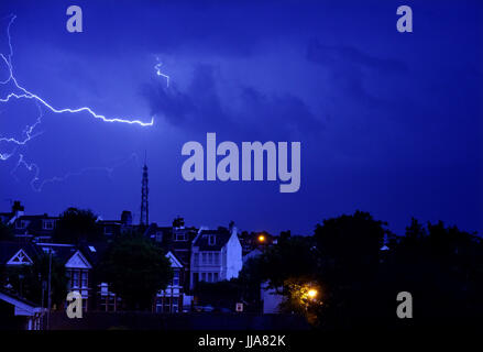 Brighton, UK. 19th July, 2017. Lightning over the television mast on Whitehawk Hill in East Brighton and homes in the Queens Park area as a thunderstorm swept across the city during the night . The storm caused damage across some parts of Britain but it is forecast to be warm and dry today Credit: Simon Dack/Alamy Live News Stock Photo