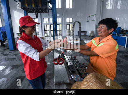 Yuyao, China's Zhejiang Province. 19th July, 2017. Volunteers send watermelons to the garbage collectors working in the sweltering heat in Yuyao City, east China's Zhejiang Province, July 19, 2017. Credit: Xu Yu/Xinhua/Alamy Live News Stock Photo