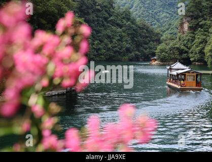 Zhangjiajie. 19th July, 2017. Photo taken on July 19, 2017 shows visitors enjoying the beautiful scenery on boat at the Baofeng Lake in Zhangjiajie City, central China's Hunan Province. The summer heat drives lots of visitors to enjoy coolness in the Baofeng Lake. Credit: Wu Yongbing/Xinhua/Alamy Live News Stock Photo