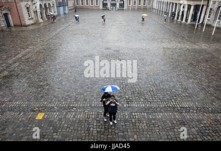 Dublin, Ireland. 19th Jul, 2017. UK Weather. Two young tourists almost have  Dublin Castle yard to themselves as the city experienced a dramatic change in weather conditions, compared to the previous few days in which the country was hit by a mini heatwave. Today and tomorrow the forecast is for heavy downpours of rain with possible thunder and lightning in some areas. Credit: RollingNews.ie/Alamy Live News Stock Photo