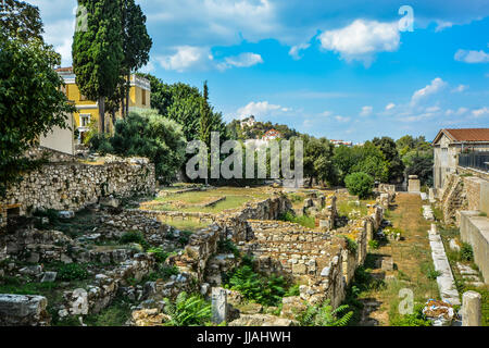 Roadside ruins in Athens Greece with a Greek church on a hill overlooking the city Stock Photo