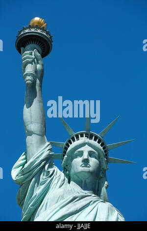Statue of Liberty frontal view in a sunny day, blue sky in New York Stock Photo