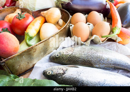Fresh trout with fruit, vegetables and eggs. Stock Photo