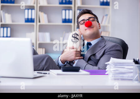 Clown businessman in the office with the a money sack Stock Photo