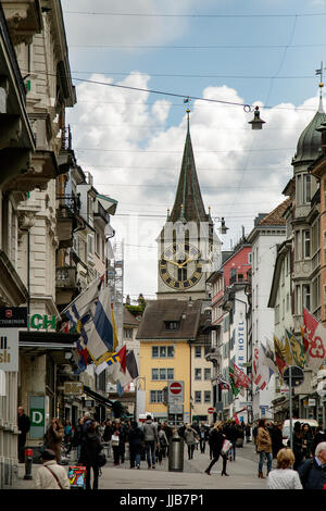 St. Peter Church clock tower, the largest clock face in Europe,  watches over the busy and historic Rennweg Street, Zurich, Switzerland. Stock Photo