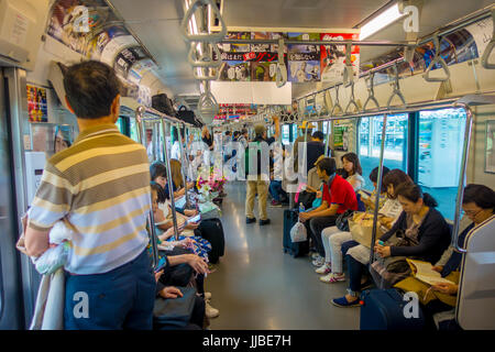 HAKONE, JAPAN - JULY 02, 2017: Unidentified people at the interior of train during rainy and cloudy day. Stock Photo