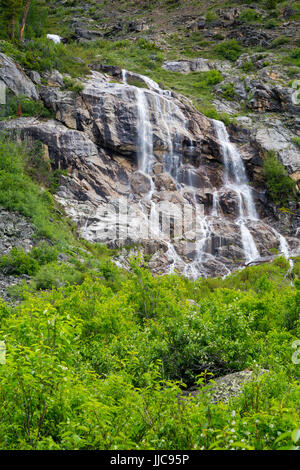 A large waterfall fed from snow melt pouring over a rocky cliff near the mouth of Death Canyon. Grand Teton National Park, Wyoming Stock Photo