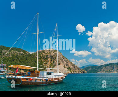 turkish tourist boat moored at Marmaris bay in Aegean sea surrounded by mountains, Turkey Stock Photo