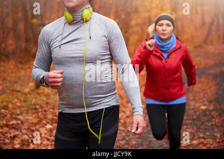 Woman following the older man in the forest Stock Photo