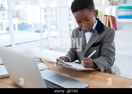 Businessman checking documents white sitting at desk in office Stock Photo