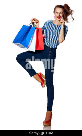 Shopping. The French way. Full length portrait of cheerful stylish fashion-monger with shopping bags of the colours of the French flag isolated on whi Stock Photo