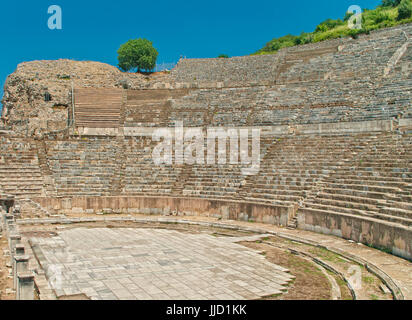 great amphitheater in ancient city of Ephesus with tree at top on sunny day, Turkey Stock Photo