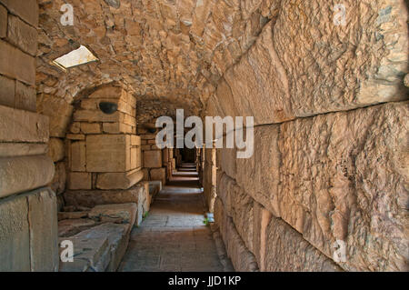 ruins of ancient greek tunnel made of stone with light shining through holes in Ephesus, Turkey Stock Photo
