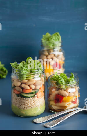 vegan couscous and pasta salad in mason jars with vegetables beans Stock Photo