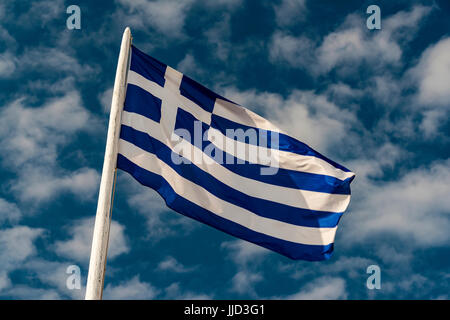 Greek flag weaving against the sky, Oia, Santorini, South Aegean, Greece Stock Photo