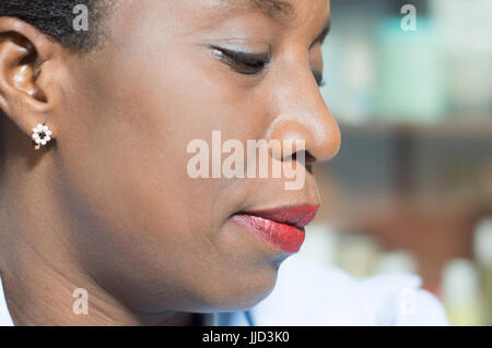 Beautiful African woman concentrated on her pedicure. Stock Photo