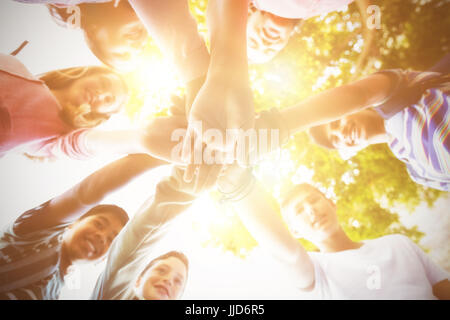 Happy school kids forming hand stack in campus at school Stock Photo ...
