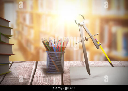 Digitally generated image of drawing compass with pencil against aisle along bookshelves in college library Stock Photo