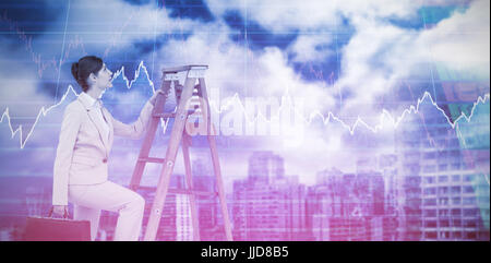 Businesswoman climbing career ladder with briefcase against stocks and shares Stock Photo