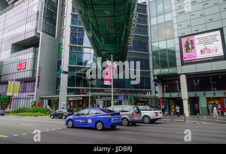 Singapore - Jun 14, 2017. Vehicles and people on Orchard Road in Singapore. Orchard Road is the retail and entertainment hub of Singapore. Stock Photo