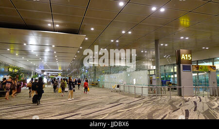 Singapore - Jun 14, 2017. People at Terminal 3 of Changi Airport in Singapore. Changi serves more than 100 airlines flying to some 380 cities in about Stock Photo