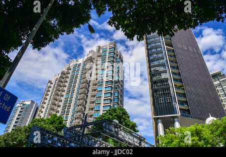 Singapore - Jun 14, 2017. Modern apartments with green trees at sunny day in Singapore. The estimated population of Singapore was 5,535,000 people in  Stock Photo