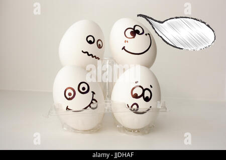 An egg with a face. Funny and cute. FOUR EGGS. DORMITORY. ON THE HEADS OF NEIGHBORS. CLOSELY. EMIGRANT. POLICY. Photo for your design. Cloud of though Stock Photo