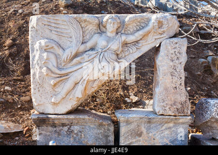 Classic White Roman angel bas-reflief wall decoration in Temple Door with stone statue in ephesus Archaeological site in turkey Stock Photo