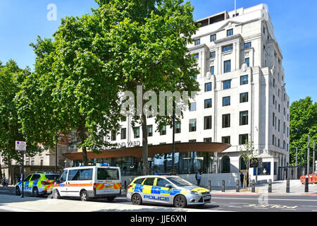 New Scotland Yard on Victoria Embankment refurbished 2015 2016 now current location & headquarters of the Metropolitan Police  with parked police cars
