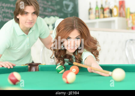 young couple playing billiard Stock Photo