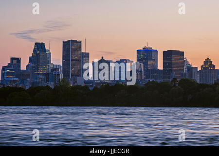 The sun sets over the skyline of Montreal, Quebec, Canada on Tuesday, July 18, 2017. Stock Photo