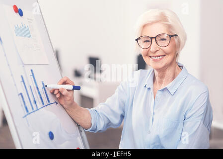 Talented economy specialist drawing a diagram Stock Photo