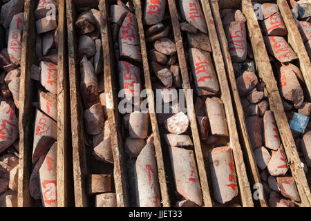 Labeled bedrock core samples collected by a drill rig from the bed of the Nam Ou River at the planned site for Dam #7 in Phou Den Din National Protected Area, Laos. Stock Photo