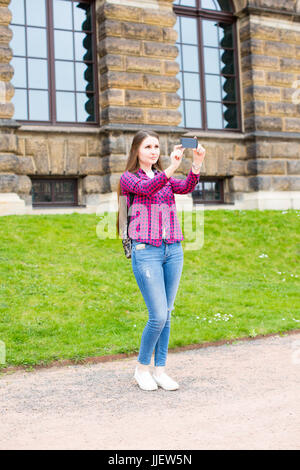 girl smartphone takes pictures of the architecture of Dresden Stock Photo