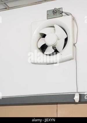Clean fan exhaust with the switch on the wall of the office building. Stock Photo