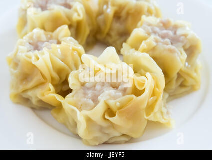 The close up of the Chinese steamed dumpling with pork on the white plate in the Chinese restaurant.(Select focus) Stock Photo