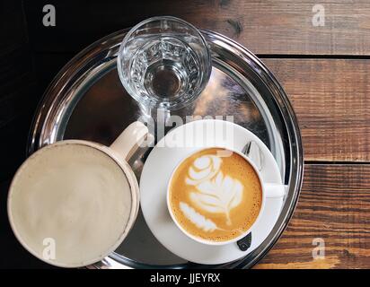Glass of a flat white coffee on rustic 