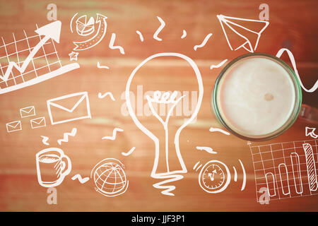 Digital generated image of light bulb amidst business icons against overhead view of coffee on wooden table Stock Photo