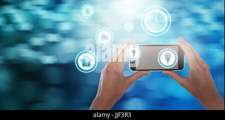 Cropped hands of businesswoman holding mobile phone against glowing background Stock Photo