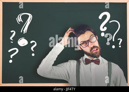 Portrait of confused man scratching head against question mark Stock Photo