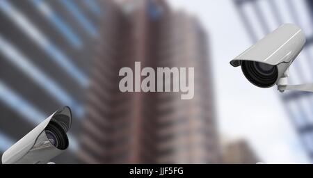 Digital composite of CCTV cameras against defocused buildings in city Stock Photo